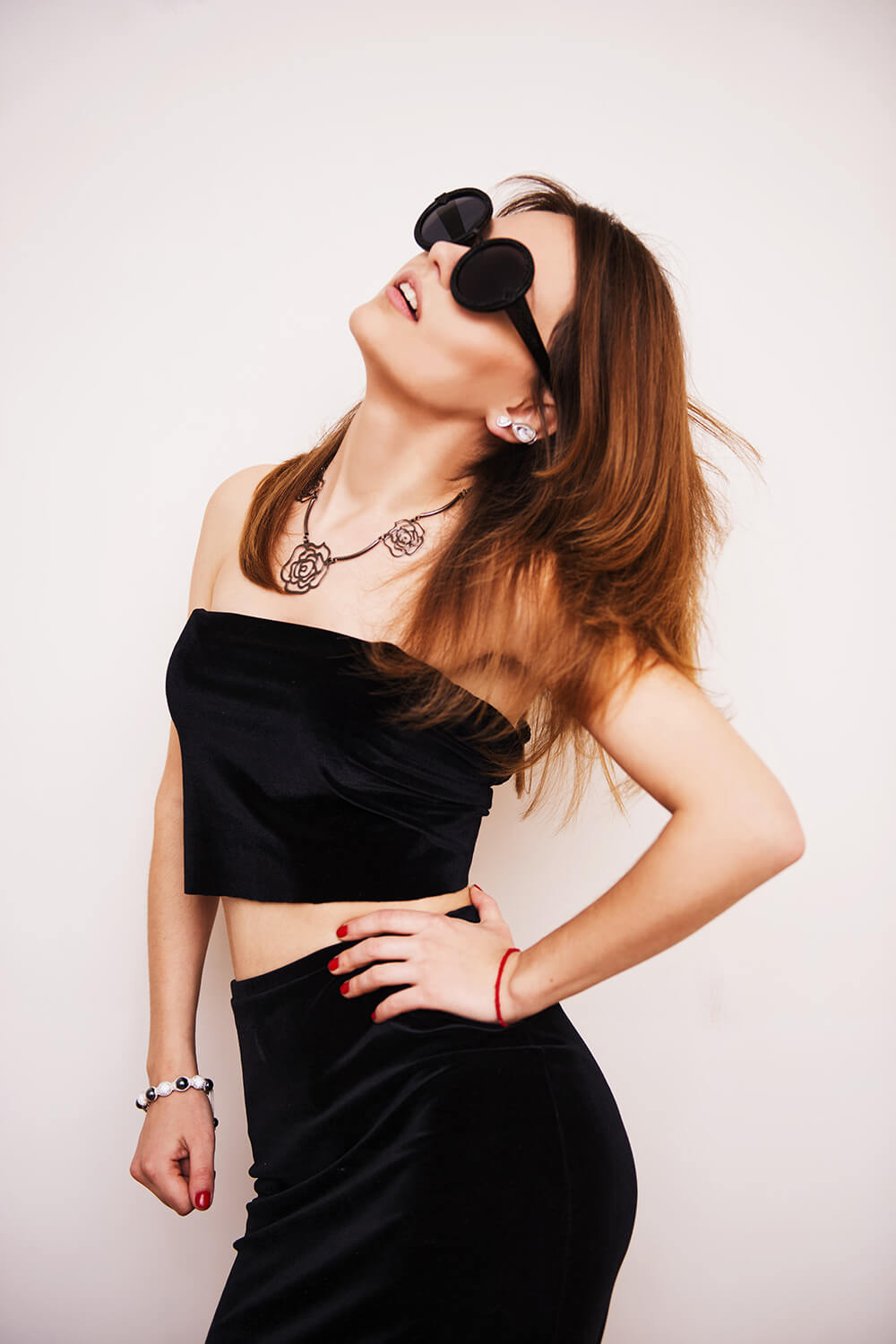 woman-wearing-black-crop-top-standing-under-white-background